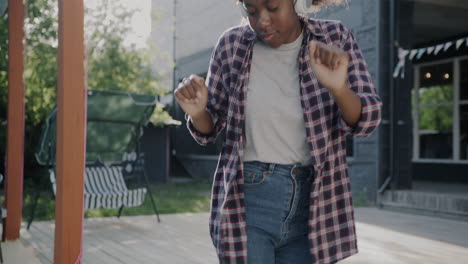 teenager dancing outdoors with headphones