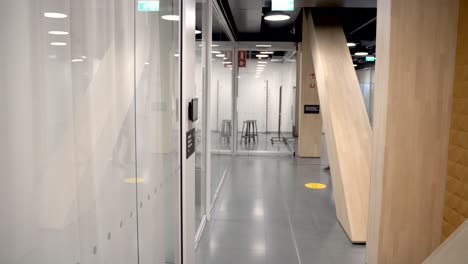 focused businessman  walks through the busy corporate building hallway.