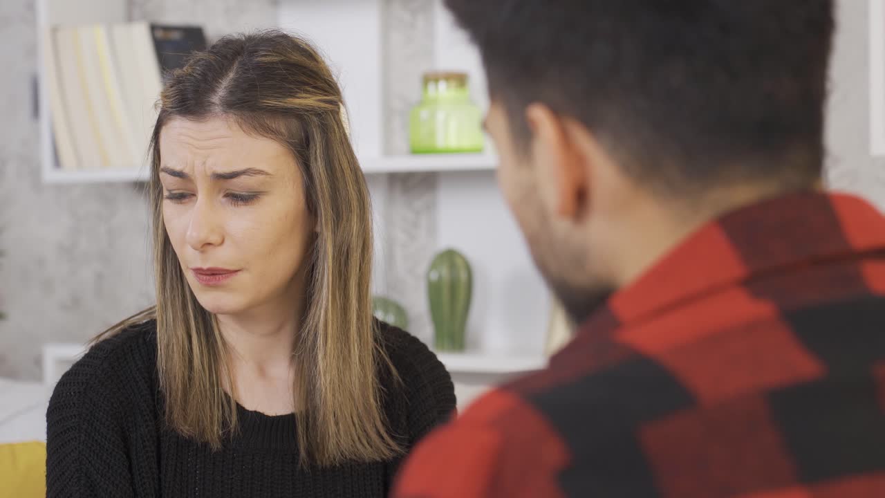 Bad breath. Young woman disgusted because her boyfriend's breath has strong odor.