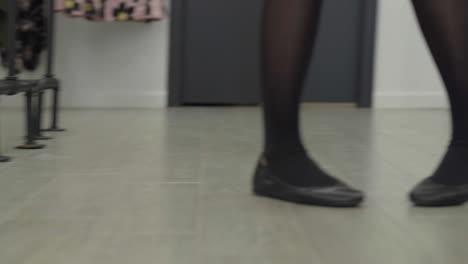 woman pacing back and forth in a store