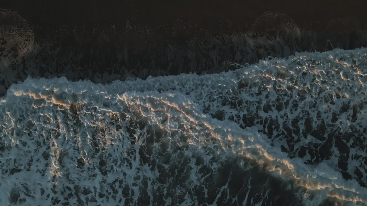 Top view of ocean waves during sunset