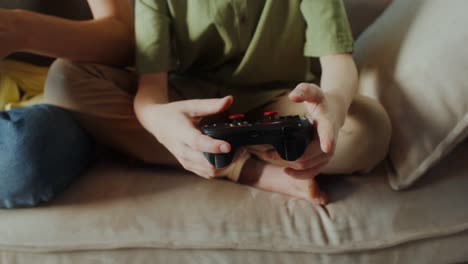 child playing video game on couch