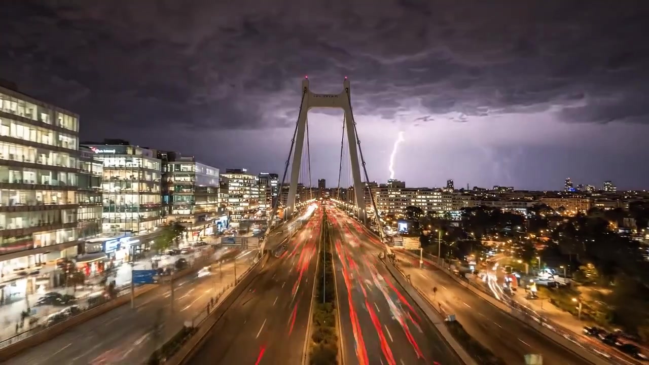 Dramatic Crossroads: A Journey Across a City Bridge Amidst Thunderstorm Clouds and Illuminating Lightning in the Night Sky Captured in Two Stunning Frames