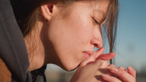 close-up of a girl resting her head on hands in a heavyhearted moment, conveying deep sorrow . her expression is filled with melancholy, as she gently holds clasped hands near face