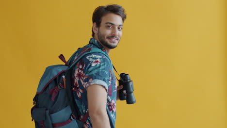 man with backpack and binoculars