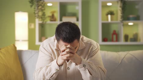 unhappy, depressed man is thoughtful and not feeling well at home.