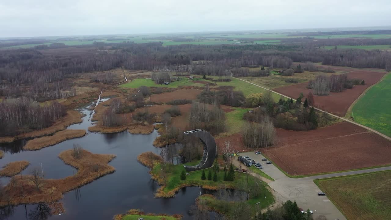 The autumn colors of the surrounding lakes are on full display as the drone flies near the watchtower, capturing the essence of the season