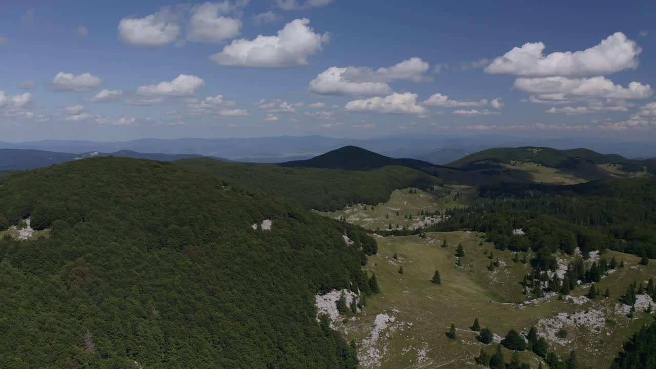 Wide drone shot capturing an open, expansive valley landscape