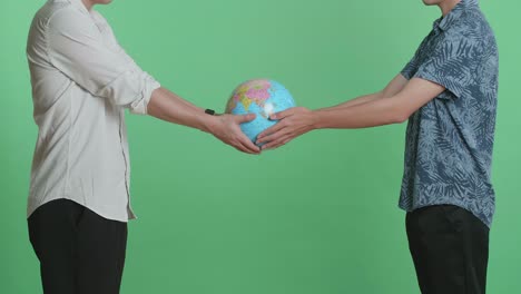 two men holding a globe