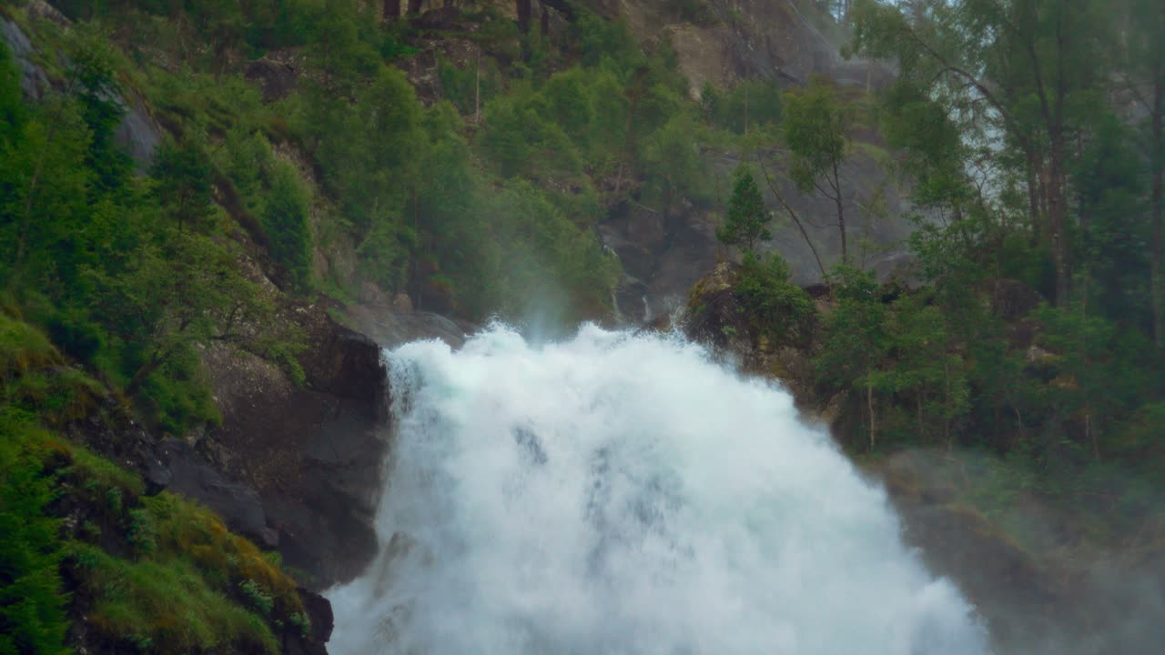 Latefossen waterfall, scenic cascade in Norway. Idyllic Scandinavia nature, lush green landscape. Slow motion.