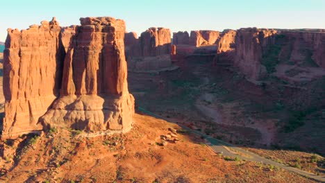 4k aerial of rock formations in a desert landscape - arches national park, utah, usa