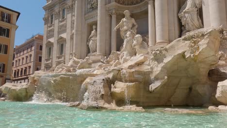 hand-held shot of the trevi fountain in rome flowing