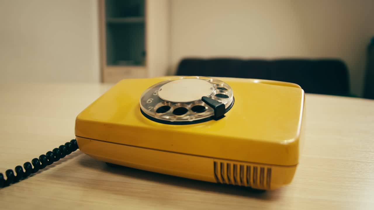 Retro vintage phone, A yellow rotary telephone is displayed on a wooden desk, adding a nostalgic touch