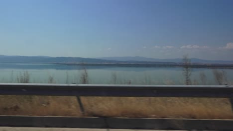 driving by lake volvi in greece