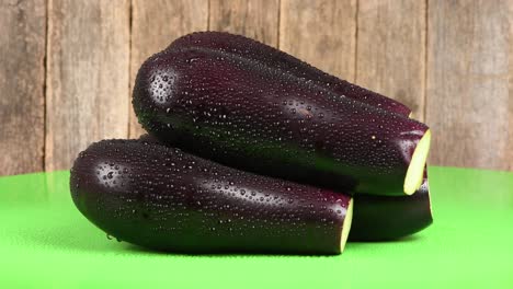 eggplant on green background. side view. loop motion. rotation 360.