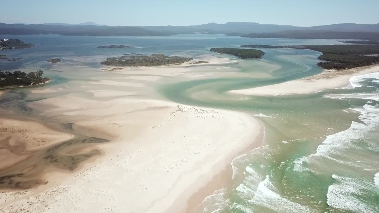 Aerial footage flying towards the mouth of the Wallagaraugh River at Mallacoota at low tide, eastern Victoria, Australia, December 2020