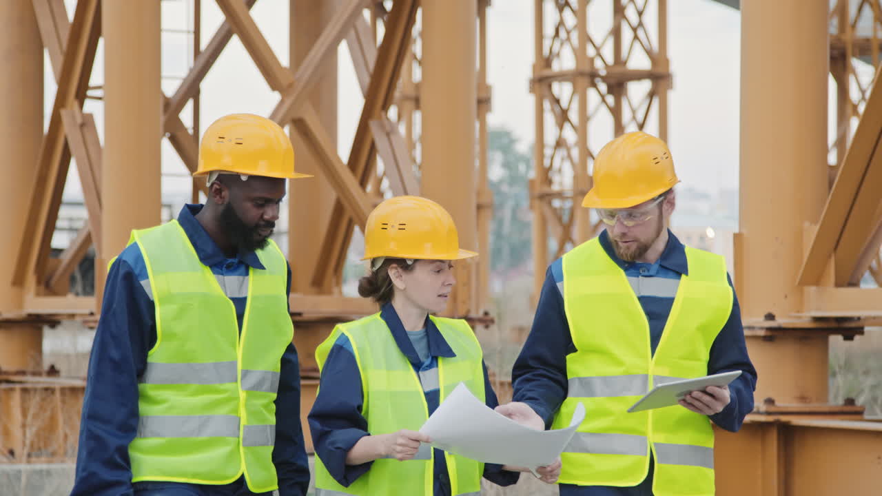 Multi-Ethnic Construction Workers Discussing Blueprint