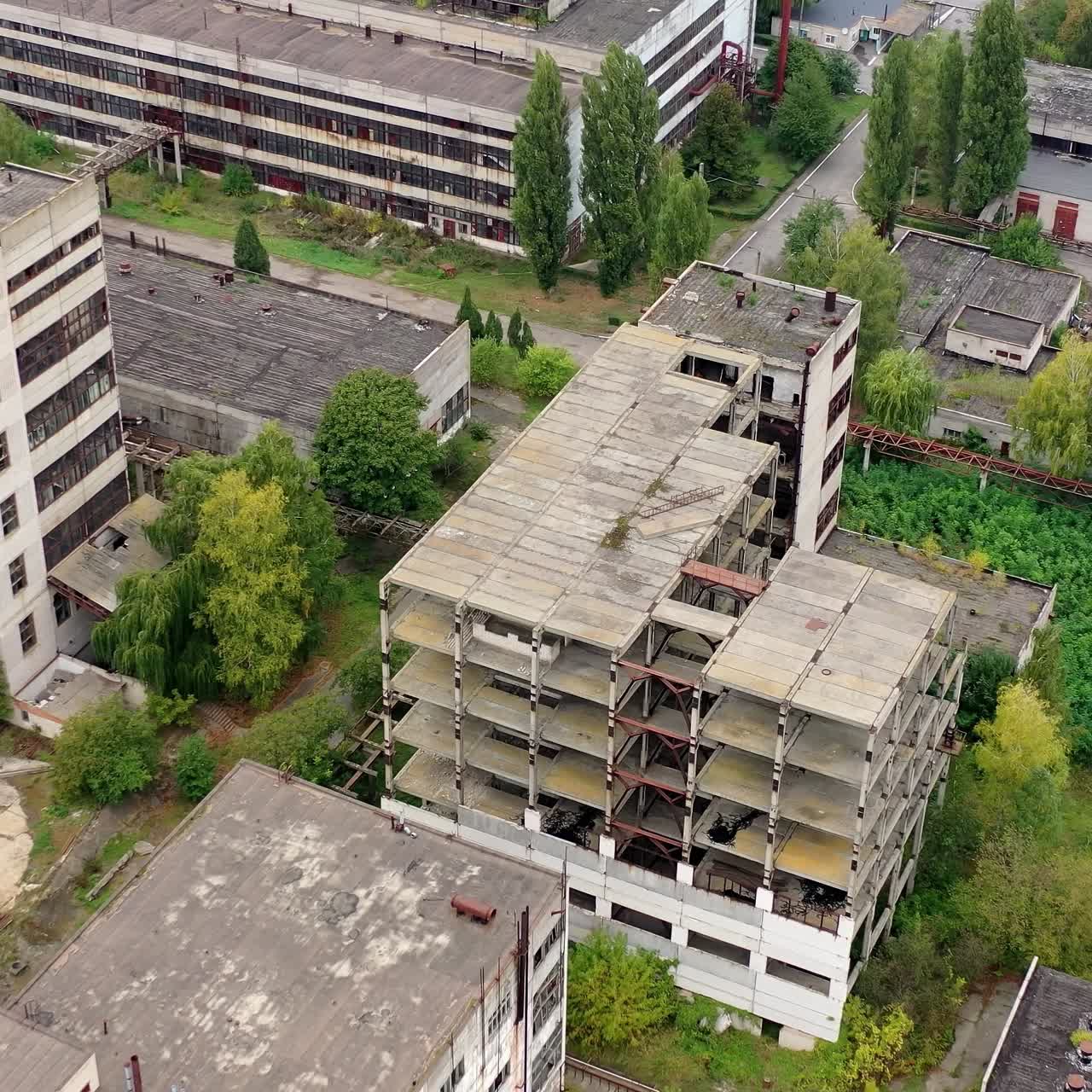 View from above of ruined and abandoned factory. Aerial view of industrial destroyed city buildings