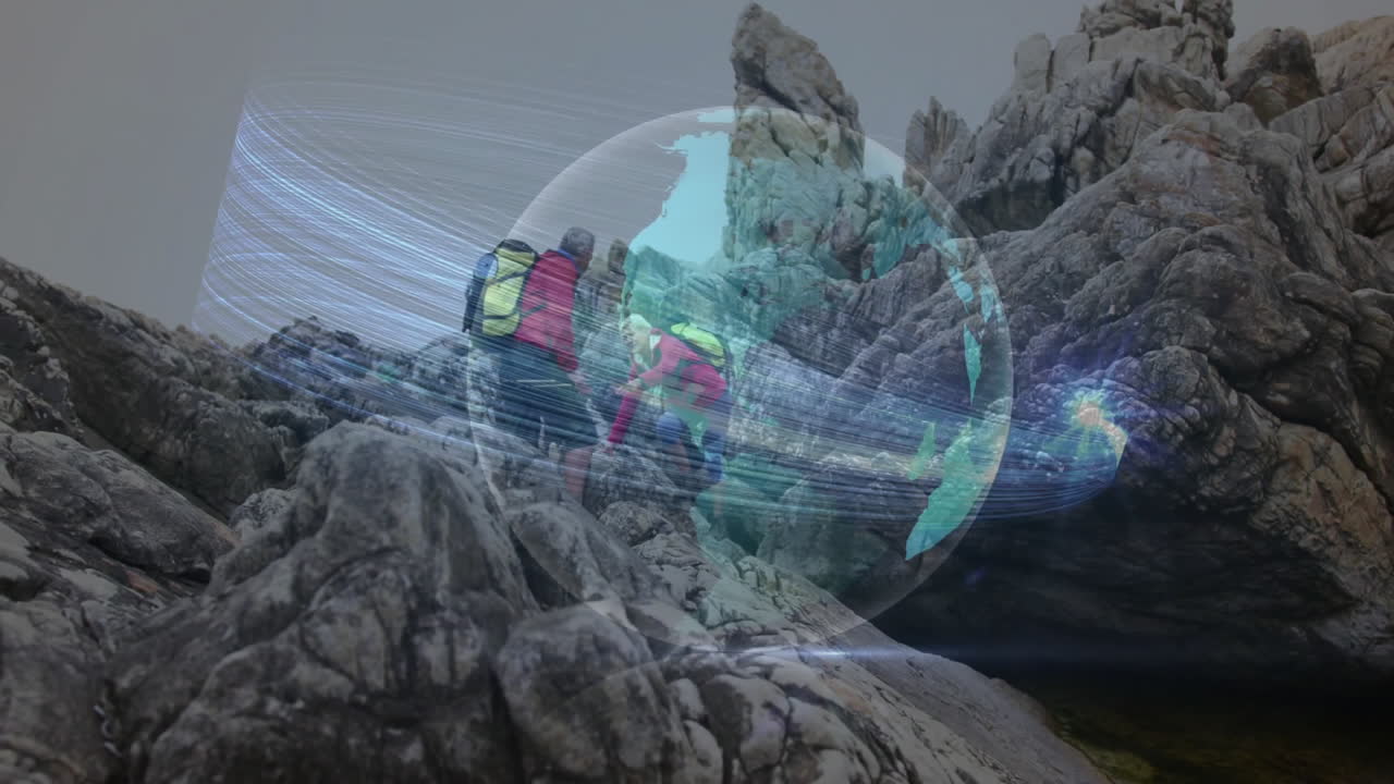 Two hikers climbing jagged coastal rocks, featuring digital globe streaming technology data lines