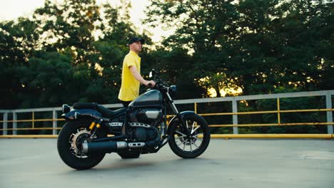 Male-instructor-at-a-driving-school-sets-the-motorcycle-to-the-correct-place.-Driving-instructor-in-yellow-t-shirt