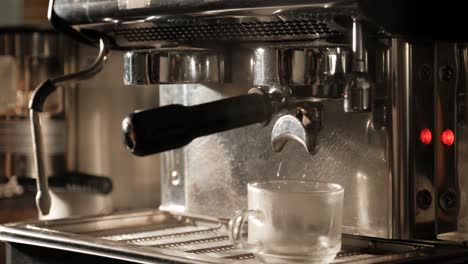 barista make hot black espresso in coffee machine