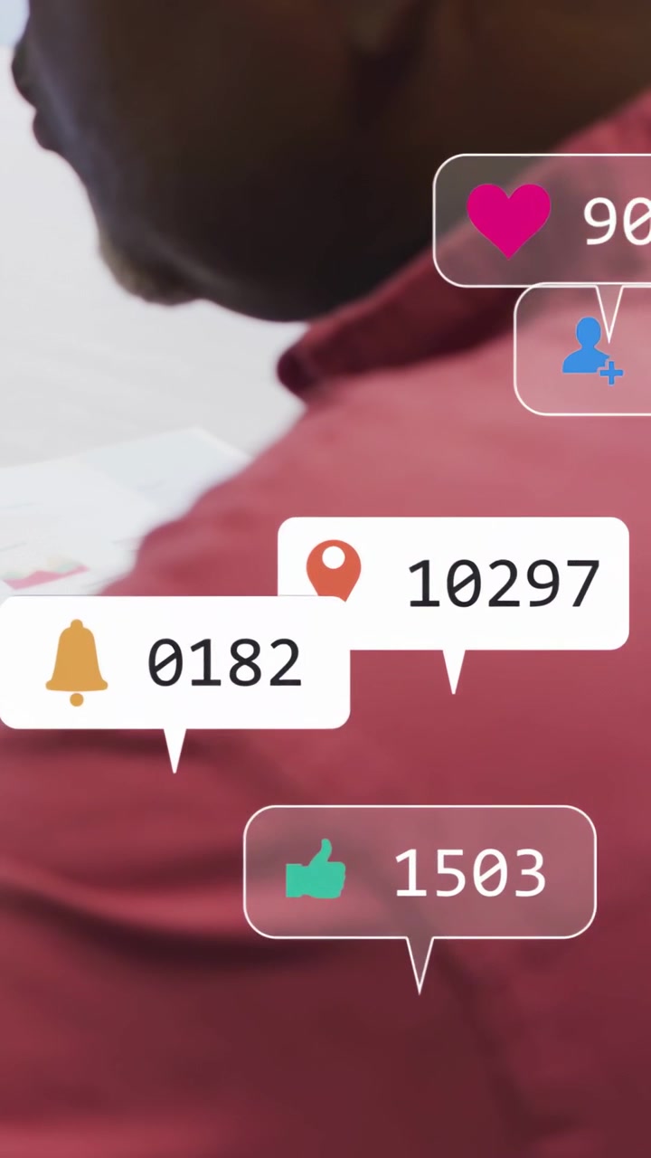 Vertical video: Incoming social alerts appearing around senior man reading docs, clustering, fading