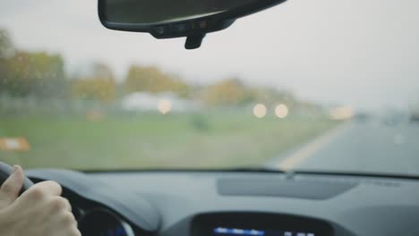 Car-Windscreen-Wipers-Cleaning-Rain-Drops-On-Windshield-During-Rainy-Day-Drive-On-The-Highway---handheld,-slow-motion