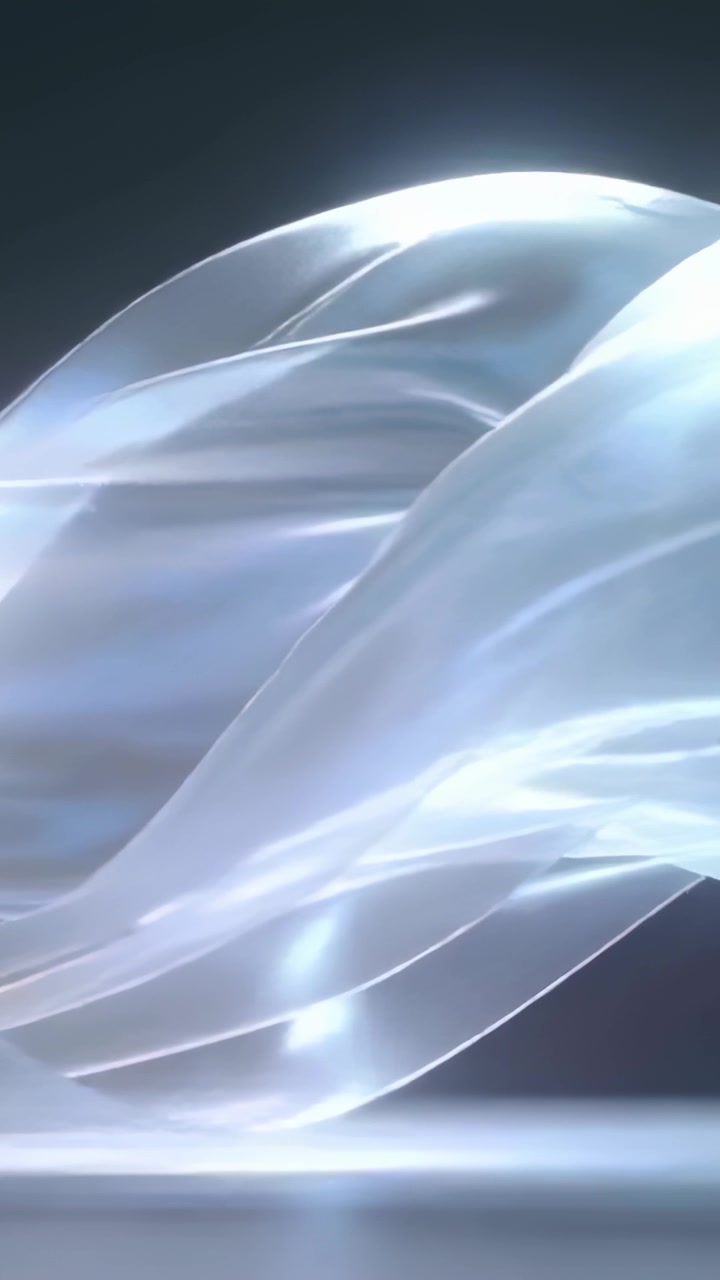 Vertical video: Flowing sheer sheet entering from right, unfolding over reflective floor in studio