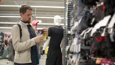 man shopping for sports accessories in a store