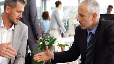 Business-people-shaking-hands-in-office