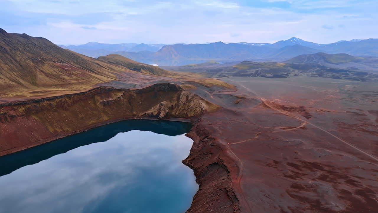 A lake locating in the crater of volcano. Barren deserted rocky land of Iceland. Aerial perspective.