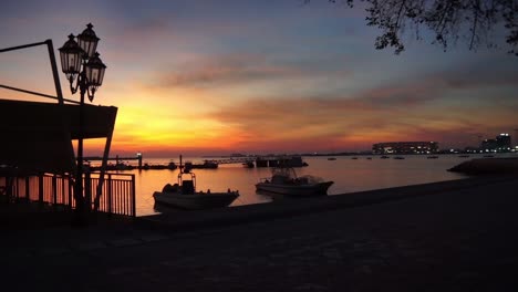 slow right pan of the sunrise over the qatar docks fish market