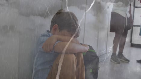 Animation-of-clouds-and-lightning-over-sad-caucasian-schoolboy-sitting-in-corridor