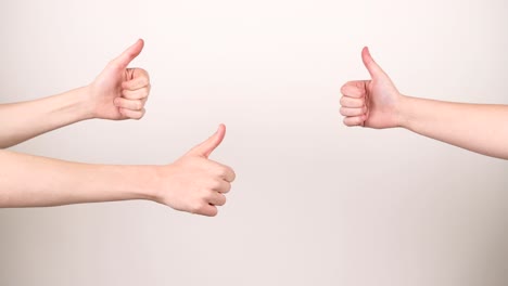 four thumbs up coming in frame one at the time on a white background