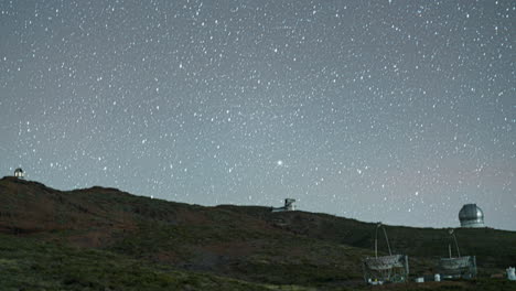 roque de los muchachos observatory on the rugged mountain landscape under a clear sky into the night, timelapse