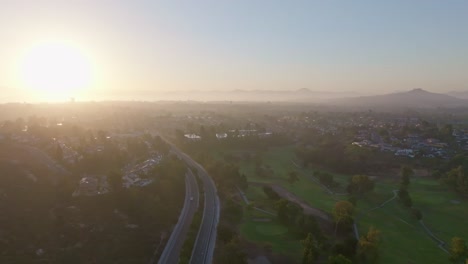 Aerial-view-of-cowles-mountain-in-san-Diego-California-during-a-bright-sunset,-slider-wide-shot