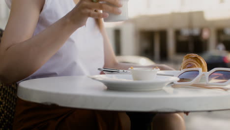 Unrecognizable-woman-sitting-outdoors