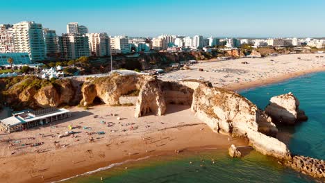 coastal view of portugal's beach with cliffs and city skyline at sunset
