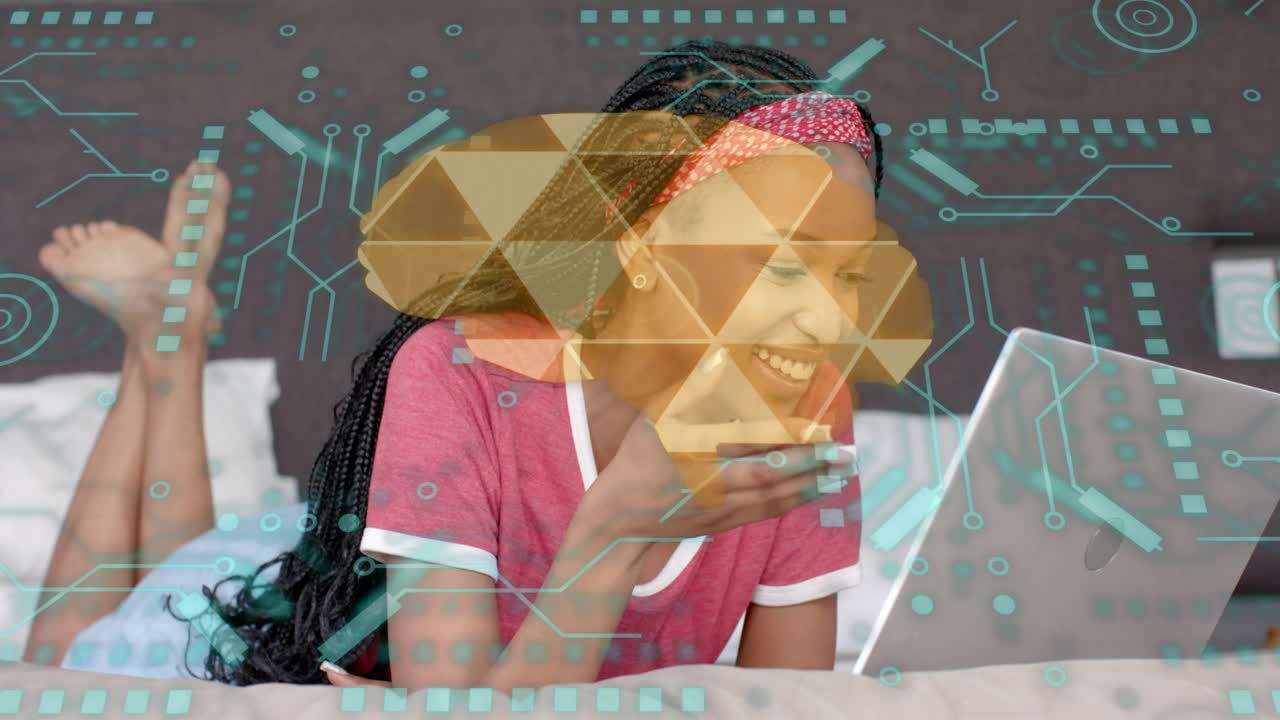 Woman on bed leaning over laptop, typing to interact with cloud technology overlay highlighting UI