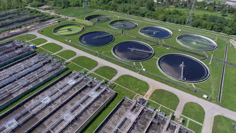 sewage farm. static aerial photo looking down onto the clarifying tanks and green grass.