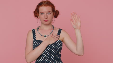 sincere responsible redhead woman raising hand to take oath promising to be honest and to tell truth