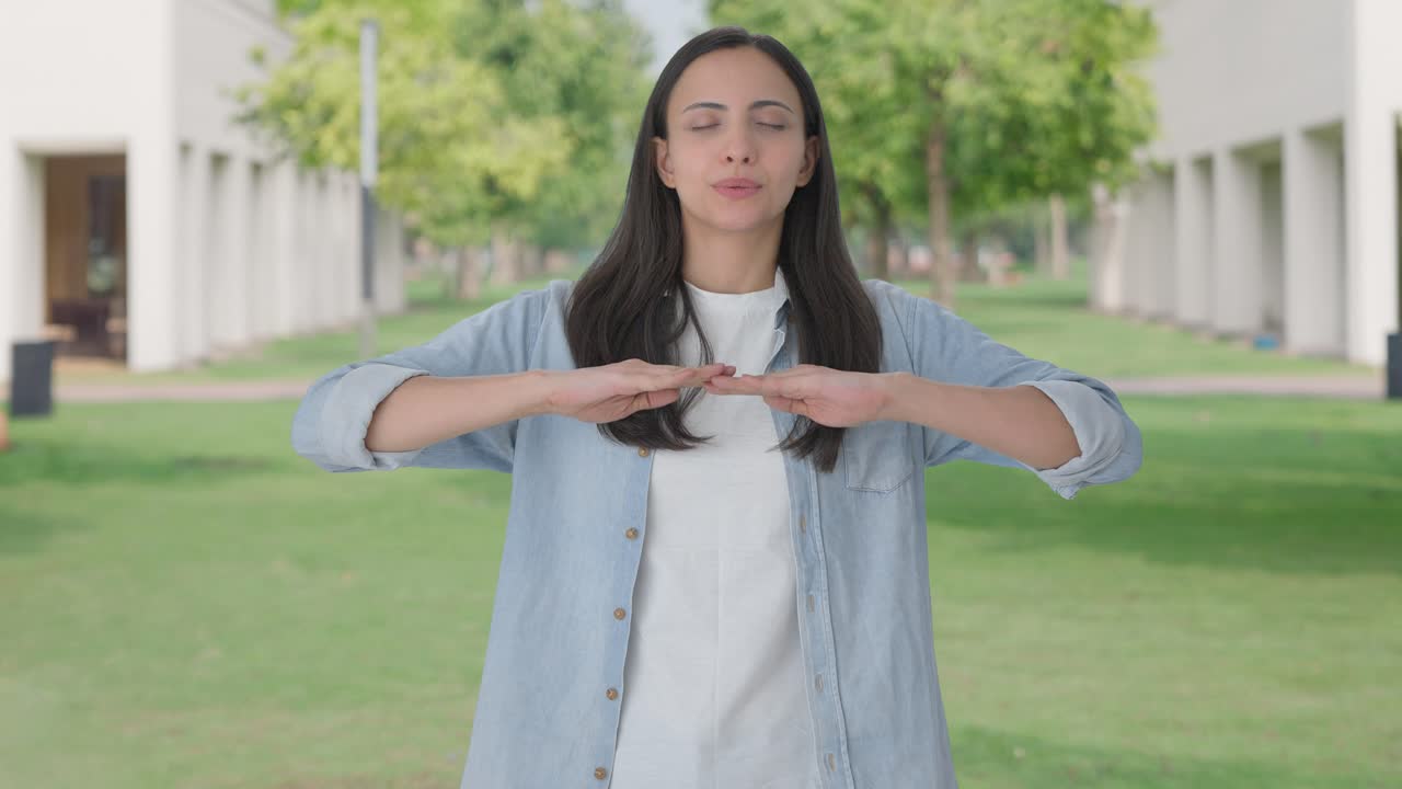 chica india feliz haciendo ejercicio de inhalación y exhalación