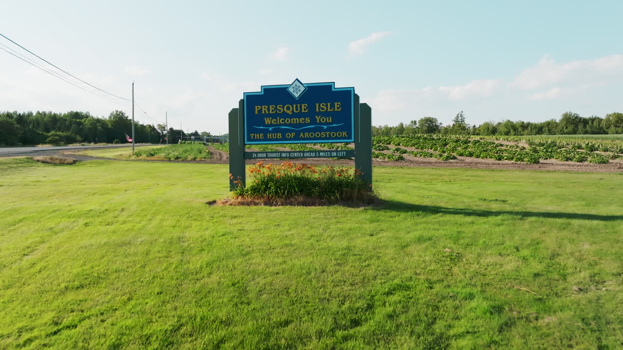 Drone Flyover of Welcome Sign to Presque Isle, Maine with Farmland in Background