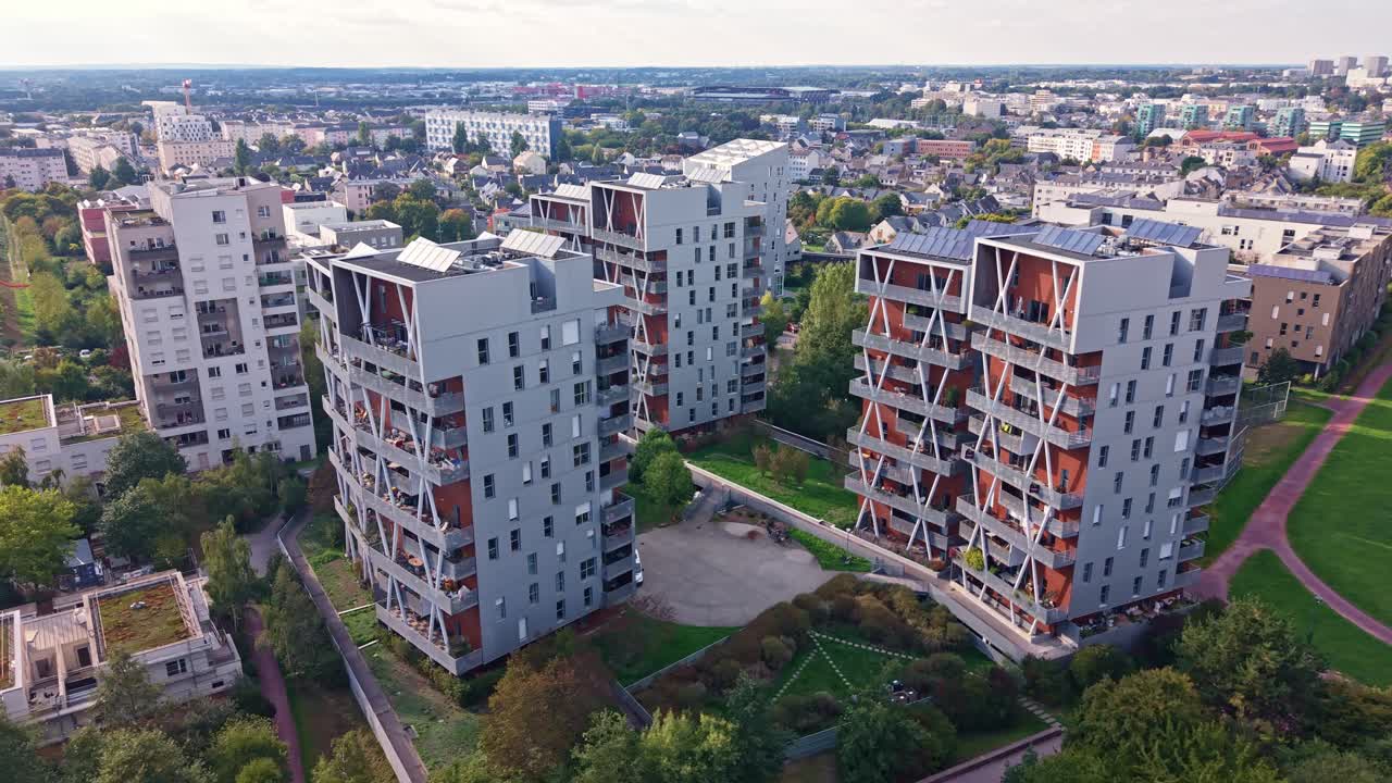 Aerial drone view of contemporary residential architecture in the La Courrouze district of Rennes, France. Modern apartment buildings feature unique facades and green surroundings