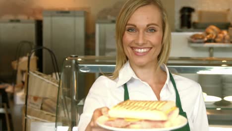 Deli-worker-offering-a-panini