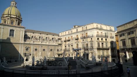 historic piazza fountain and church in italian city