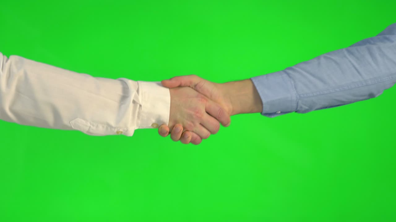 Handshake on a green background in 4k slow motion 60fps | Premium Stock ...