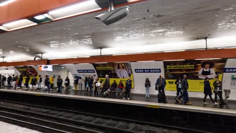 crowded subway platform with people and banners