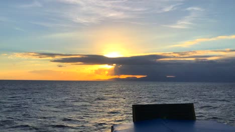 Watching-the-sunset-from-a-bit-boat-in-Bali,-Indonesia