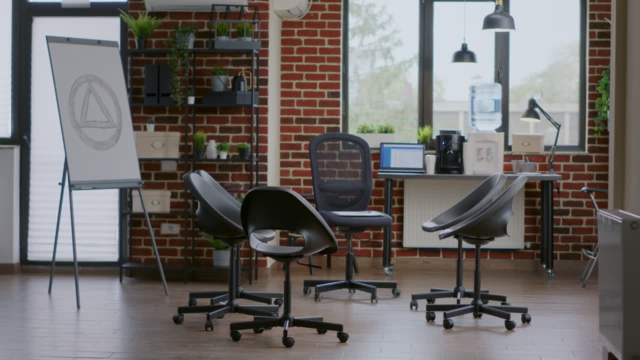 Nobody in group therapy space decorated with chairs in circle and aa meeting sign on white board